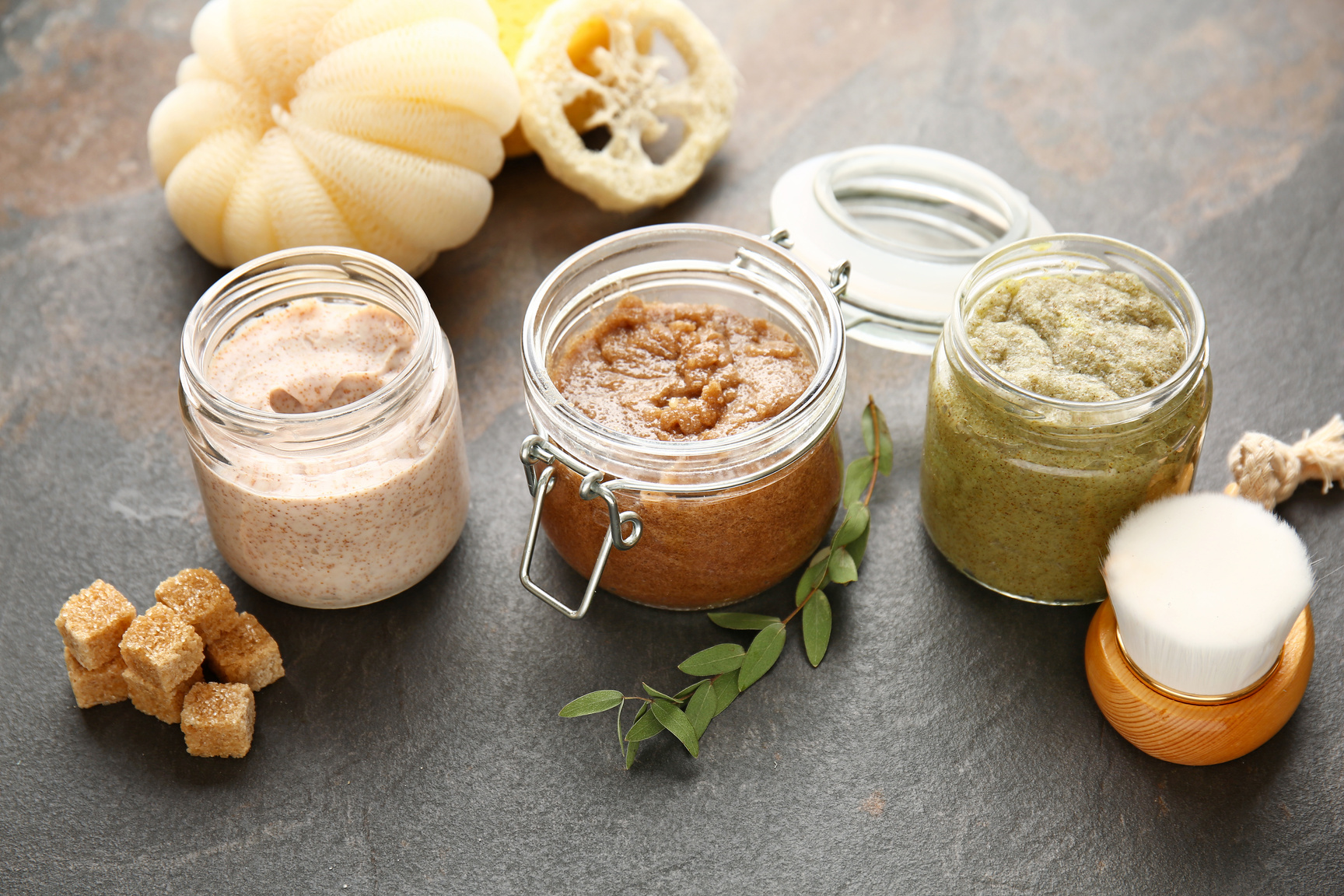 Assortment of Sugar Scrubs on Dark Table