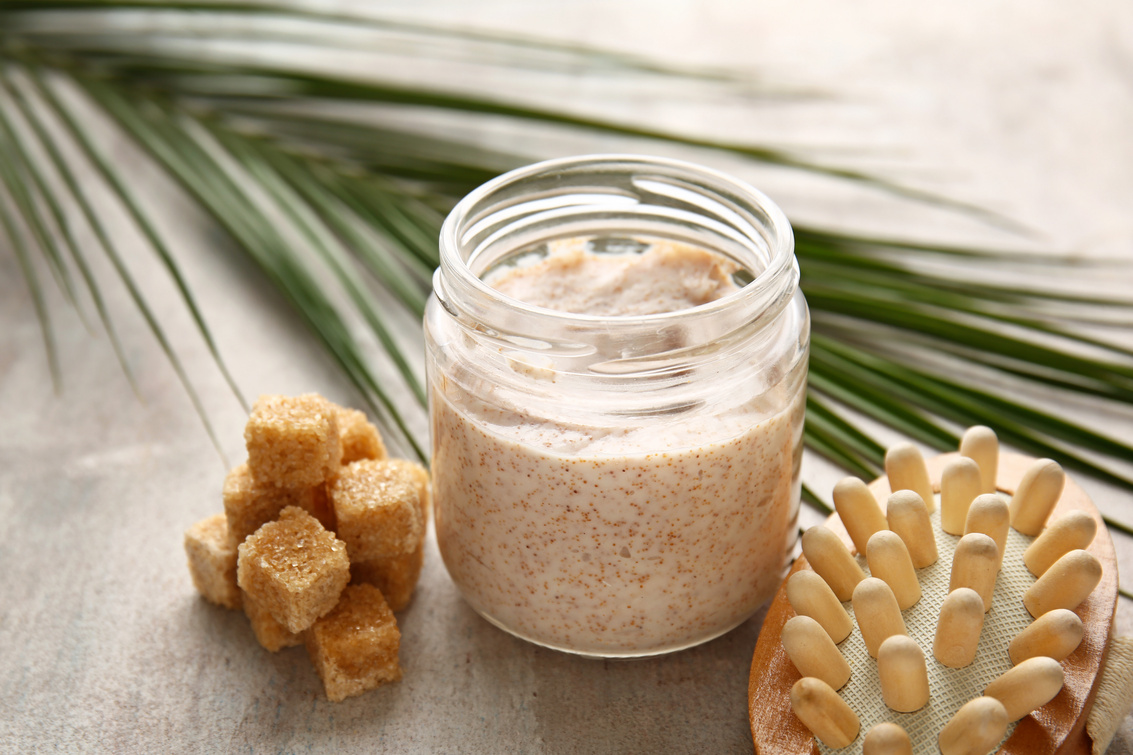 Sugar Scrub with Massage Brush on Grey Background