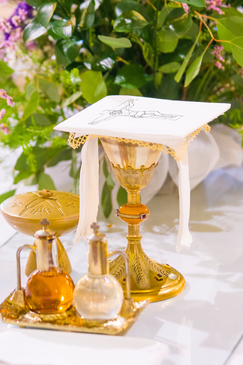 chalice for wine, blood of christ, and ciborium with host, body of christ, and ampoules with wine and water for consecration